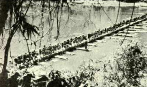 Vietnamese troops transport logistics across a rudimentary pontoon bridge