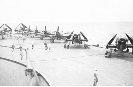 A French aircraft carrier with folded-wing fighter planes on its deck in the Gulf of Tonkin, providing support for Điện Biên Phủ.
