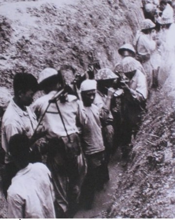 Soldiers in the trenches during the rainy season